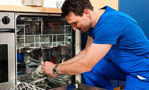 man working on dishwasher