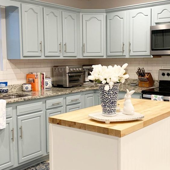Sherwin-Williams Stardew is a light blue gray paint color that can breathe new life into old oak cabinets
